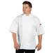 A man wearing a white Uncommon Chef Venture Pro Vent chef coat.