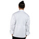 A man wearing a white Uncommon Chef long sleeve chef coat with a mesh back.