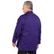 A man wearing a grape long sleeve chef coat with mesh back.