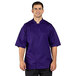 A man wearing a purple Uncommon Chef short sleeve chef coat with a mesh back.