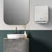 A Kimberly-Clark Professional ICON Automatic Paper Towel Dispenser with a cherry blossom faceplate above a sink and mirror in a bathroom.