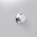 A close-up of a white knob on a silver dispenser.