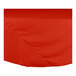 An orange Intedge poly/cotton blend round table cloth on a table.