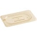 A Cambro 1/9 size amber plastic lid with a hole in it.