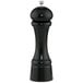 A black pepper mill with a silver top.