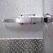 A stainless steel door handle on a metal door.