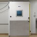 A white metal door for a Bally walk-in freezer with a square window.