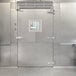 The stainless steel door of a Bally Walk-In Cooler.