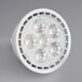 A close-up of a TCP dimmable LED light bulb with a white background.