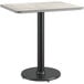 A Lancaster Table & Seating table with a black base and a reversible gray and white top on a black pole.