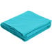A teal Intedge rectangular cloth table cover folded on a white background.