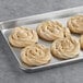 A tray of Orange Bakery ready to bake Danish snails on a gray surface.