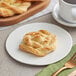 An Orange Bakery Danish snail pastry on a plate with a fork.