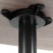 A Lancaster Table & Seating black metal base on a table with a white wood surface.