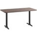 A Lancaster Table & Seating white birch and ash laminated rectangular table top on black table legs.
