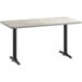 A white rectangular table with a reversible white and gray top on black table legs.