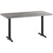 A Lancaster Table & Seating rectangular table with black legs and a gray wood surface with a white border.