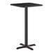 A square, black bar-height table with a single central pedestal and a four-pronged cast iron base.