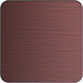 A close-up of a square wooden table top with a cherry wood finish.
