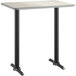 A Lancaster Table & Seating bar height table with a black base and white and gray reversible top.