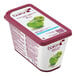 A container of yogurt with Les Vergers Boiron Green Apple Fruit Puree on top.