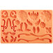 An orange silicone mold with various flowers and leaves.