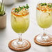 Two glasses of Les Vergers Boiron green apple fruit puree with garnish.
