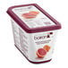 A container of yogurt with Les Vergers Boiron Pink Grapefruit puree on top.