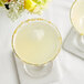 Two martini glasses with Les Vergers Boiron Bergamot puree and ice on a table.