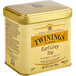 A gold and white Twinings tea tin with a lid.