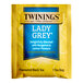 A yellow and blue box of Twinings Lady Grey tea bags.