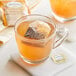 A glass mug with a Twinings Honeybush, Mandarin & Orange tea bag in it.