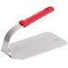 A Vollrath steak weight with a red silicone handle.
