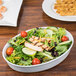 A salad with chicken and shrimp on a CAC porcelain oval serving platter.