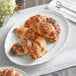 A plate of Schulstad Ready to Bake Mini Assorted Filled Croissants on a white surface.