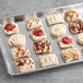 A tray of Schulstad ready to bake mini assorted Danish pastries with 5 flavors.