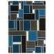 A blue and black rectangular area rug with squares and lines in a white room.