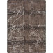 A Joy Carpets Umber area rug with abstract designs in brown and white, including a crack in the middle.