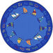 A round multicolored area rug with sailboats, flags, and letters in blue, white, and orange.