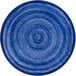 A blue circular rug with a spiral pattern.