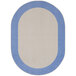 A light blue oval rug with white border and blue accents.