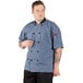 A man wearing a Uncommon Chef Havana short sleeve chef coat.