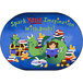A girl and a dragon reading books on a multicolored oval area rug.