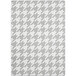 A grey and white houndstooth patterned fabric rug.