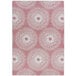 A white and pink rectangular area rug with circular designs in pink and white.