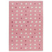A blush pink and white rectangular rug with white dots.