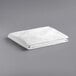 A stack of folded white Oxford Super Blend king size bed toppers.