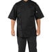 A man wearing a black Uncommon Chef Calypso Pro Vent chef coat.