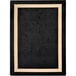 A black and beige rectangular area rug with a white border.