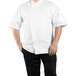 A man wearing a white Uncommon Chef Calypso Pro Vent chef coat with a mesh back.